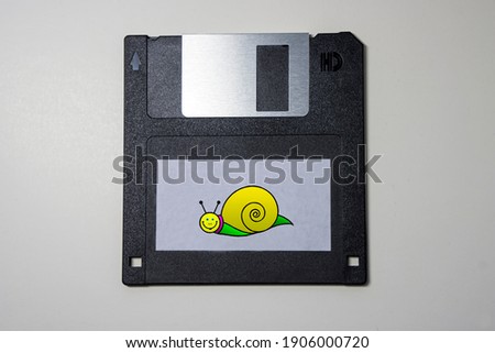 Outdated floppy disk with a snail on the label