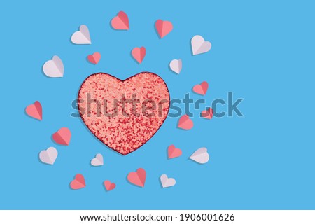 Symbols of love for Happy Women's, Mother's, Valentine's Day, birthday greeting card design. Flat lay ,texture. Paper elements in the shape of a heart on a blue background. 