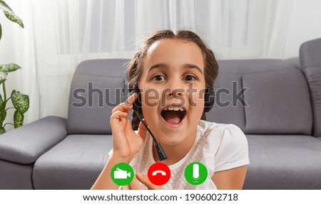 Headshot portrait screen view of little preschooler girl sit on couch talk on video call with parents, smiling small child laugh speak online use Webcam conference conversation on gadget