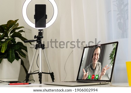 laptop with videoconference stands on the table