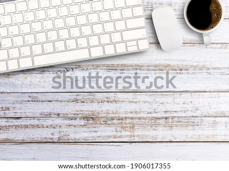 Top view with keyboard,mouse wireless and cup of coffee on white wood desktop in office workplace. copy space for your design.