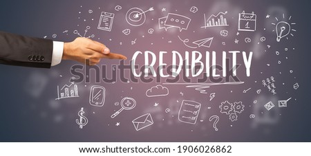 Close-Up of cropped hand pointing at CREDIBILITY inscription, modern business solution concept