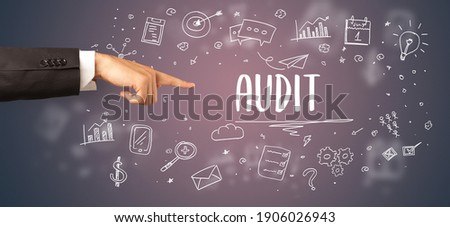 Close-Up of cropped hand pointing at AUDIT inscription, modern business solution concept