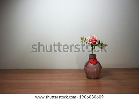 Pink rose flowers in vintage vase on wooden table, floor, gray cement wall Stylish stock image format for banner templates, text artwork, quotes, fonts, festivals