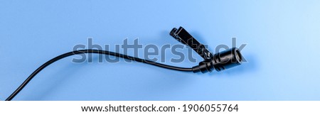 Banner of lavalier microphone on a blue background. Horizontal photo banner for website header design