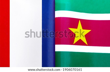 fragments of the national flags of France and the Republic of Suriname close-up