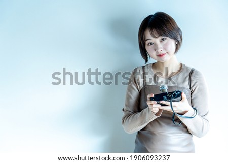 A woman enjoying a film camera