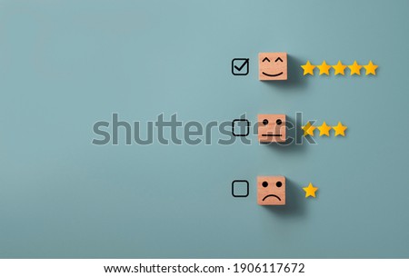 Check mark to select smile face with five stars on blue background , Customer evaluation concept. Royalty-Free Stock Photo #1906117672