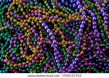 Colorful Mardi gras beads background. Green, purple and gold Merdi gras beads