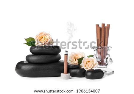 Composition with smoldering incense stick, roses and spa stones on white background Royalty-Free Stock Photo #1906134007