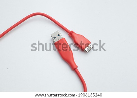 Red color USB cable isolated on white background. Connectors and sockets for PC and mobile devices