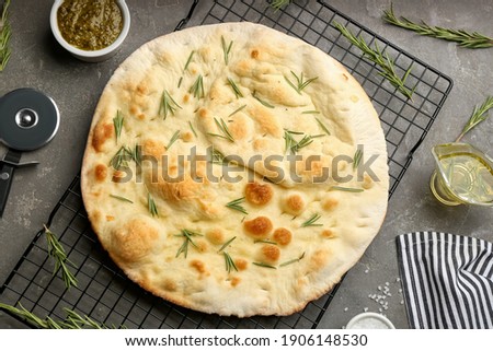 Flat lay composition with focaccia bread on grey table Royalty-Free Stock Photo #1906148530