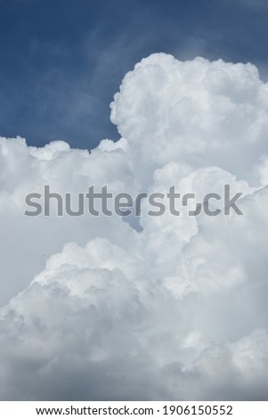 some pictoresque white clouds in the blue sky Royalty-Free Stock Photo #1906150552