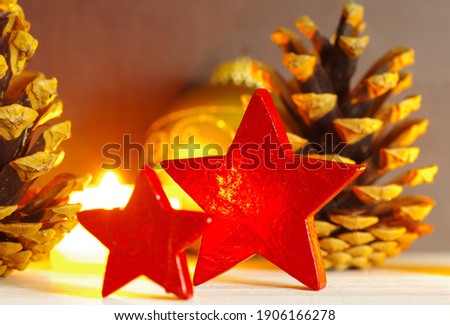 Shiny christmas decoration in a golden light with red stars