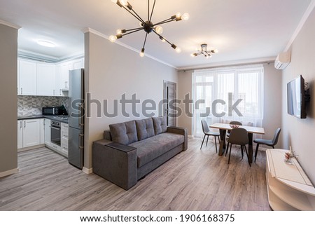 Interior photography, modern living room with kitchen studio, loft style, in bright colors Royalty-Free Stock Photo #1906168375