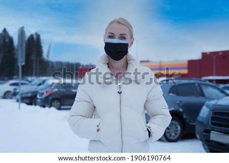 double mask on the face. A woman wearing two medical masks at the same time, blue and blue