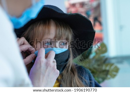 double mask. the girl is wearing a second mask in the mall