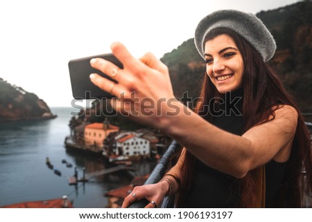 Tourist taking a selfie from a viewpoint