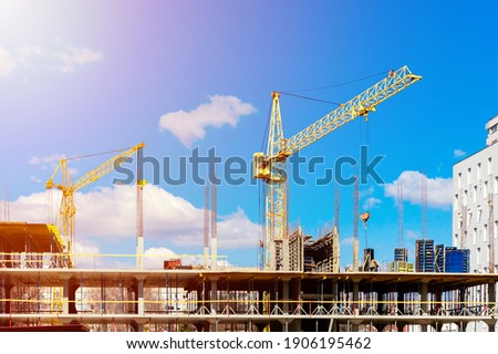 residential apartment building business concept. hoisting crane on background of building site. construction conceptual.