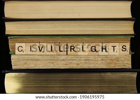 View on stacked old books with word civil rights (focus on center of lettering)