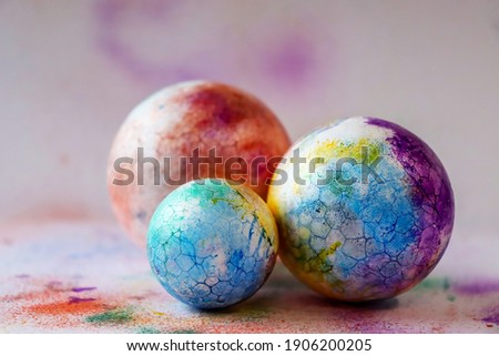 Multi coloured sprinkle cracked spheres close up. Tie dye pattern background. Minimal abstract Easter creative concept.
