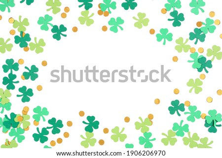 St Patricks Day shamrock and gold coin confetti frame isolated on a white background with copy space