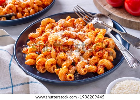 Delicious cavatappi pasta with tomato sauce and parmesan cheese. Royalty-Free Stock Photo #1906209445