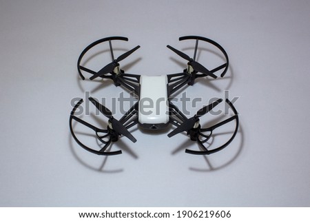 Wing-protected drone with four propeller cameras. Creative shooting drone with shadow. Isolated in white background.