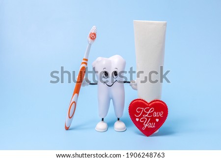 a cartoon model of a tooth, a toothbrush, toothpaste and a heart with the inscription-I love you. the concept of care for the oral cavity