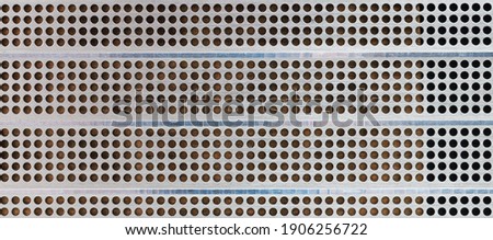 Iron grid texture background silver metal pattern with reflective round holes