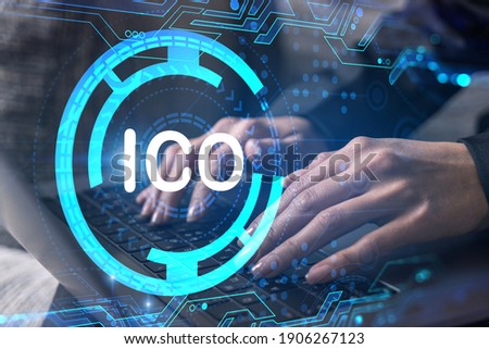 Businesswoman typing on computer in office. ICO icon hologram. Double exposure.