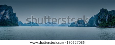 Early morning landscape with blue fog and tourist junks floating among limestone rocks at Ha Long Bay, South China Sea, Vietnam, Southeast Asia. Travel background, three images panorama
