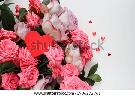 Happy Valentine's Day greeting card. beautiful bouquet of roses and red heart. space for text 