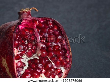 Pomegranate on black marble background