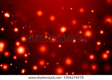 Blurred bright bokeh background. Defocused red lights over dark background