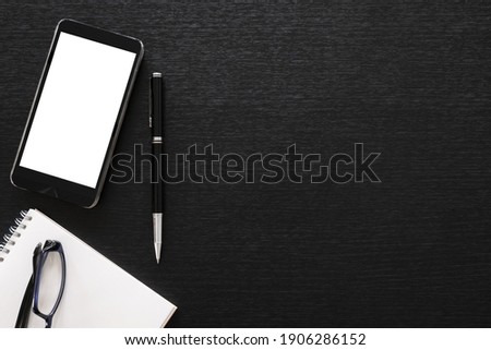 black office wooden desk table with computer, tablet, mobile phone, and office supplies - table top view with copy space