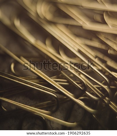 Close up image of gold paper clips with no people 