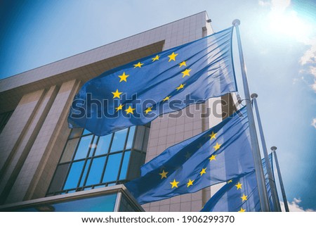 EU flags in front of European Commission building in Brussels, Belgium