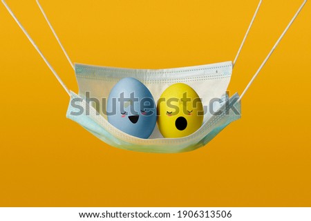 Easter eggs in a pandemic. Easter eggs with painted faces in a hammock.
singing eggs