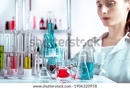 The laboratory assistant holding laboratory glass. Selected focus on the beaker