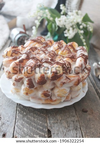 cake with eclairs, chocolate and cream 