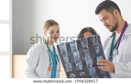 Doctor watching x-ray photography of elder woman