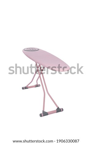 Empty ironing board isolated on pink.