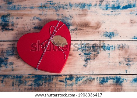 Heart Gift box with ribbon on wooden background