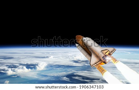 Space shuttle on orbit of Earth planet. View from outer space. Spaceship flight. Launch and expedition. Elements of this image furnished by NASA.