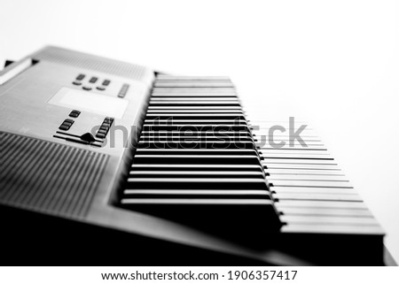 Piano keyboard in profile against white background