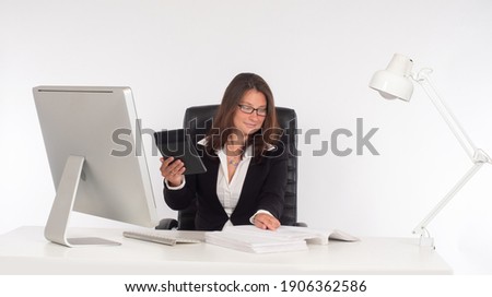 Woman accountant during work. Accountant with a calculator in his hands. Concept - work in an audit firm. Woman auditor next to the computer. Accountant on a white background. Audit business