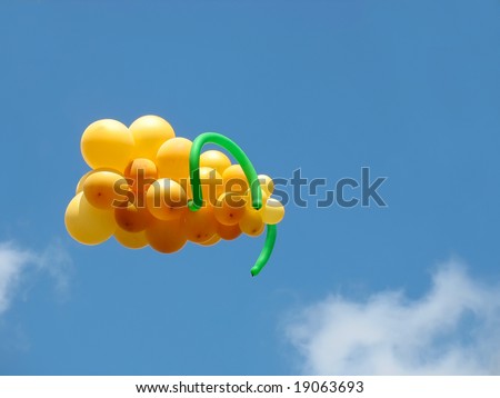 Sheaf of balloons in the form of grapes cluster against the blue sky