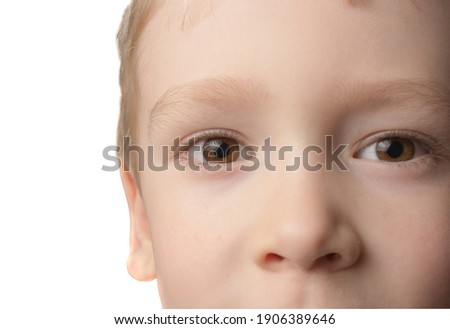 close-up face of a little boy with brown eyes and blond hair. isolated on white background. copy space.