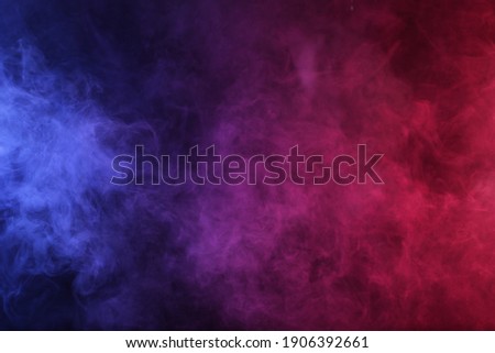 Smoke in red-blue light on black background Royalty-Free Stock Photo #1906392661